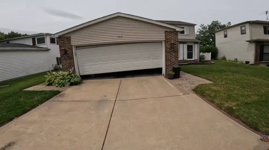 Two-car residential garage door and concrete driveway on a suburban home in Lubbock, Texas