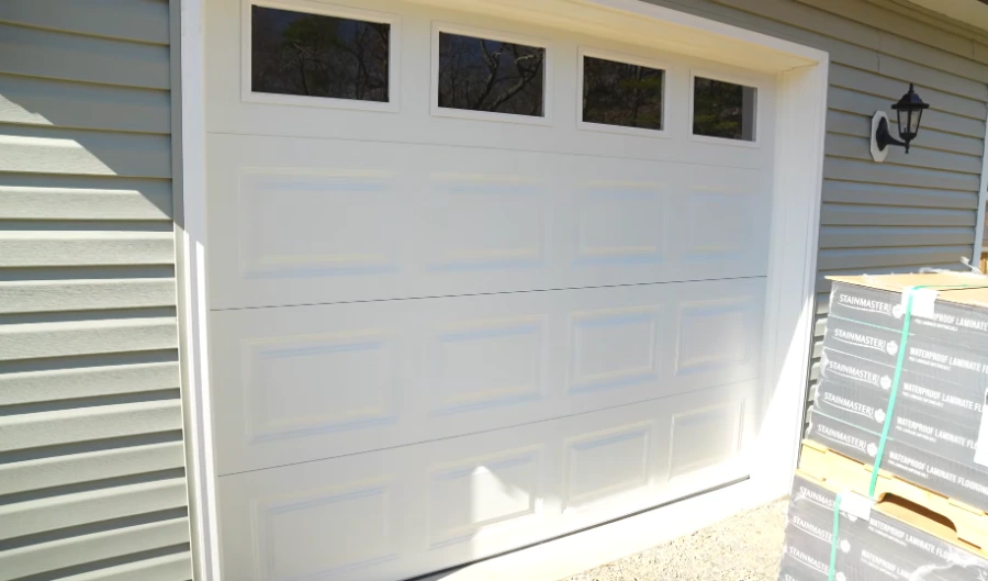 White raised-panel garage door with a row of top windows on a residential home in Lubbock, TX